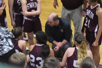 Coach Michael Turner talks to his athletes of the Swain County High School girls basketball team