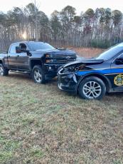 Officer Hampton’s patrol car and the offender’s truck after the chase finally ended when officers surrounded the truck prevented the driver from fleeing again.