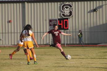 Lady Devil Karena Cline shoots the ball down field at the home game March 23.