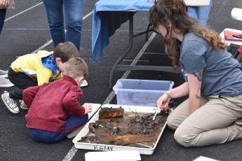Children participate in an hands-on activity hosted by the Great Smoky Mountains National Park at a previous Swain High Science Club Earth Day Celebration. 