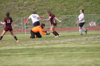 The Tri-County goalie gets the ball ahead of offense moves from the Lady Devils.