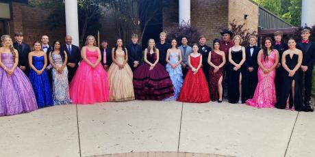 Homecoming court is pictured with their escorts on homecoming