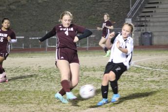 Senior Anna Gray goes in for a kick at the scrimmage Thursday evening, in which the Lady Devils practiced alongside Mountain Area Christian Academy.