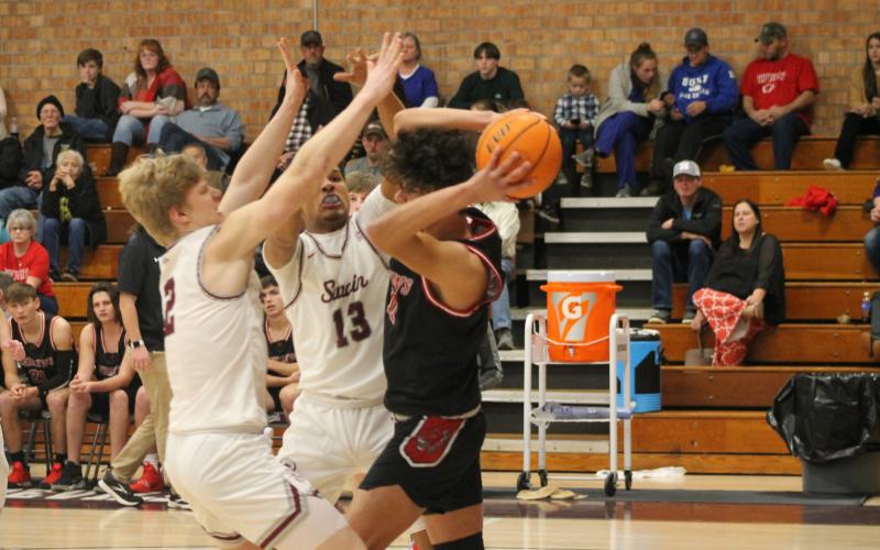  Ray Bradley (left) and Josiah Glaspie of Swain County High's varsity basketball team try and intercept the opposition at the Jan. 24 home game.Credit: Larry Griffin/SMT