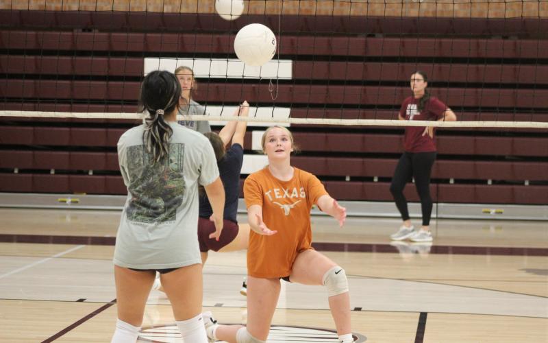 The Lady Devils volleyball team has been practicing hard as the upcoming season grows closer, according to coach Lydia Sale. They meet daily in the high school gym, where they spread out in pairs and practice lobbing the ball back and forth.