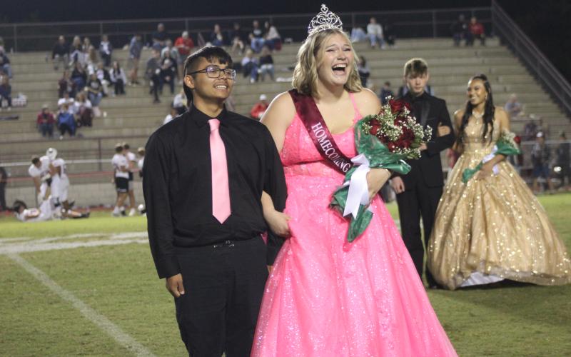 Senior Riley Cabe (right), escorted by Alijah George at the football game Sept. 29, was crowned Homecoming Queen for this year. Cabe, asked if she had any comment, said, “I cannot believe it, that’s all I got.”