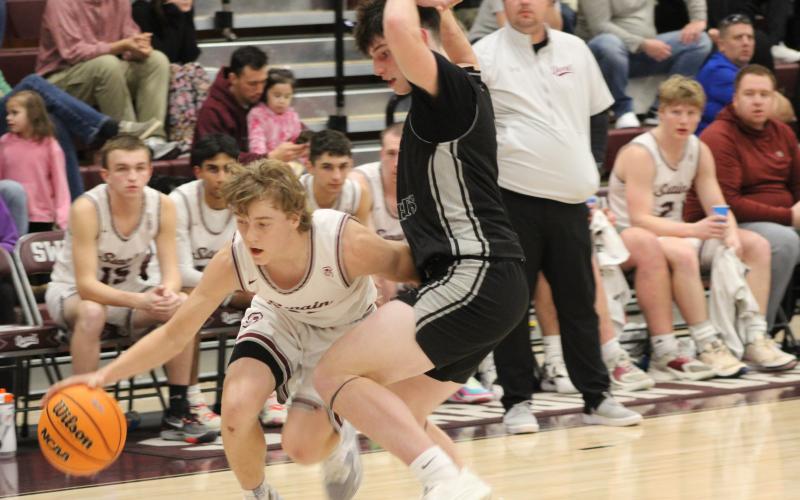 Sophomore Druw Cody tries to break through the Black Knights’ defense to get to the hoop at the game played at home Friday, Feb. 9.