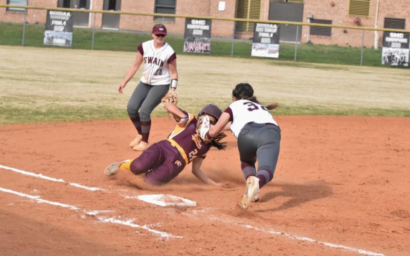 Freshman Allie Stephenson (front) tags out a Lady Braves opponent at the home game Monday, March 25.