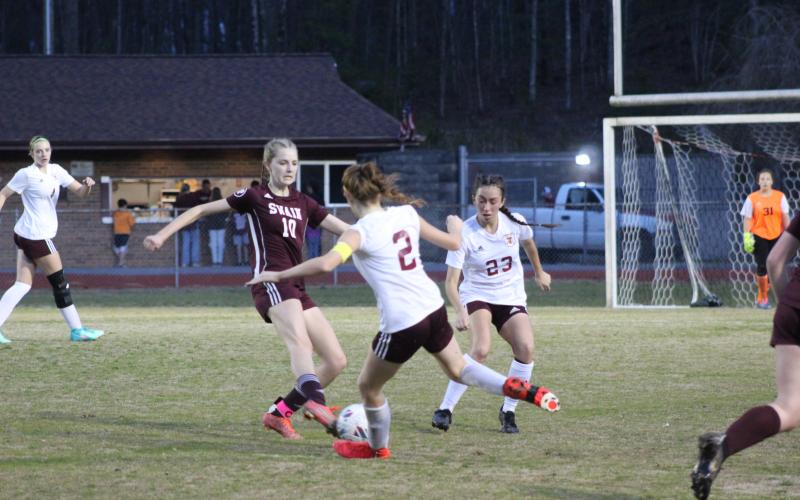 Junior Mya Burrows-Kurr tussles with opponents from Thomas Jefferson Classical Academy at the game Thursday, March 7, which the Lady Devils lost 3-2 in a tight game.